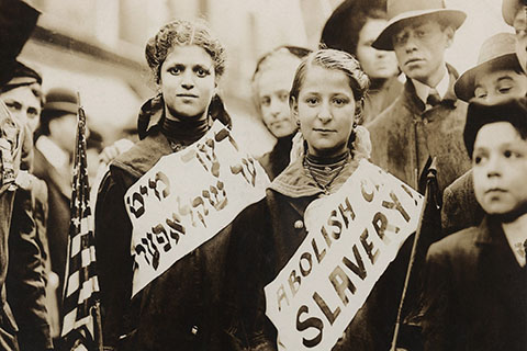 This is a stock photo. Jewish citizens in American holding signs in English and Yiddish advocating for the abolition of slavery.