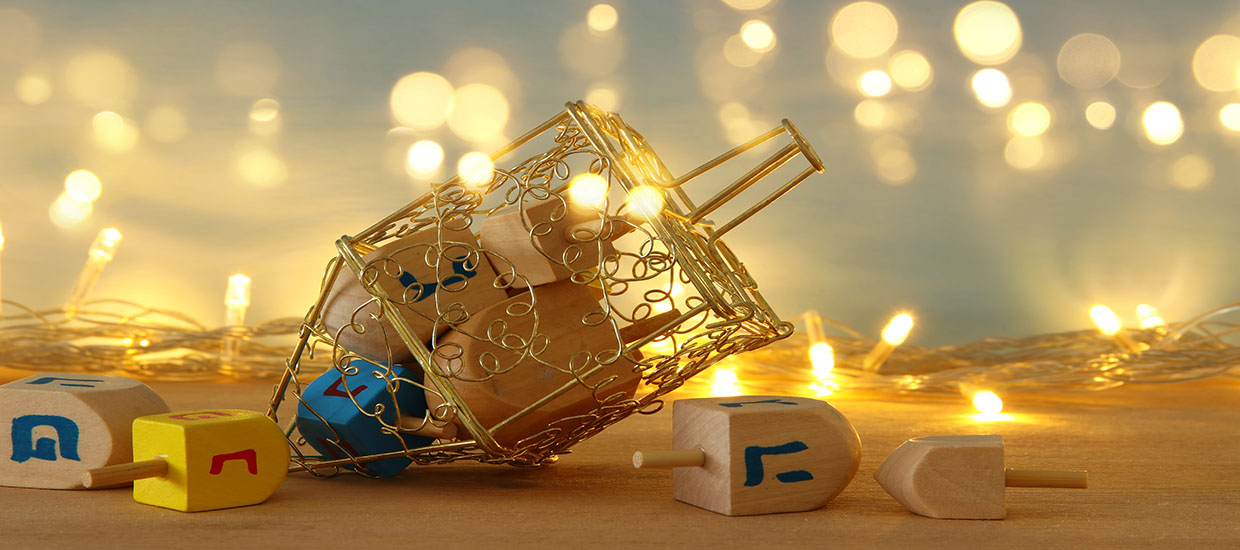 This is a stock photo. A dreidel surrounded by twinkling lights.