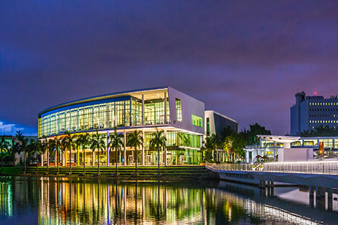 This is a photograph of the Shalala Student Center at the University of Miami at night.